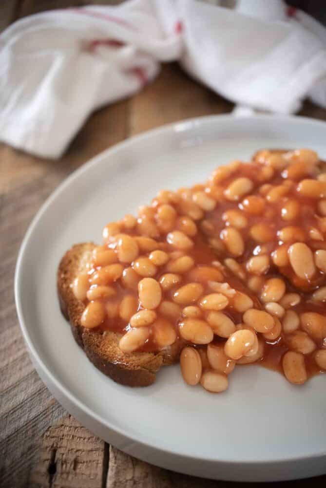 British baked beans served over toast on a white plate