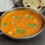 A chicken balti curry topped with cilantro/coriander