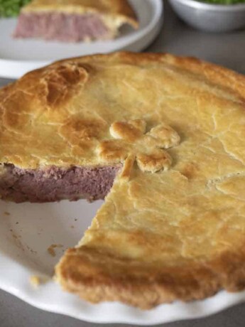British Corned Beef and Potato Pie with a slice removed