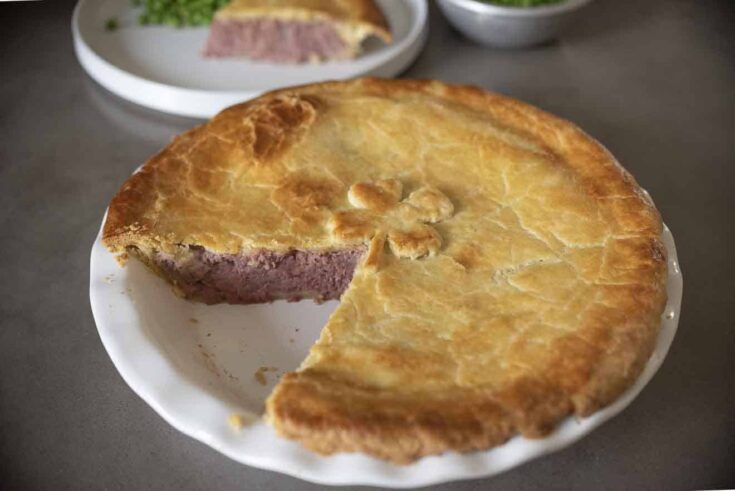 British Corned Beef and Potato Pie with a slice removed