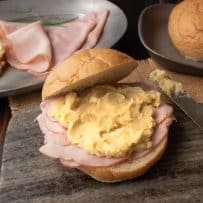 Pease pudding served with ham on a bread roll