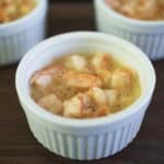 Poached shrimp in butter in a white bowl