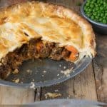 A whole and a slice of steak and ale pie