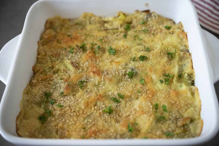 A crispy breadcrumb topping and chopped parsley on top of leeks in cheese sauce