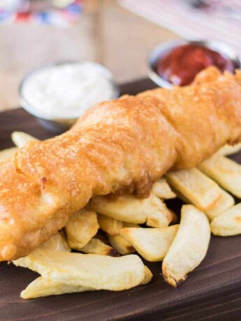 British fish and chips served with peas, ketchup and tartar sauce