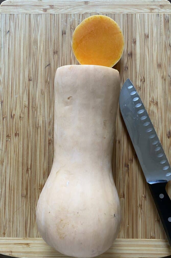 A whole butternut squash with the end cut off