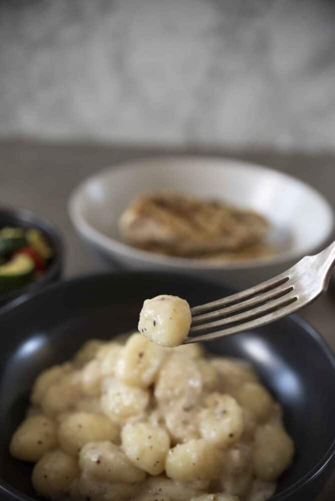 A potato gnocchi on the end of a fork