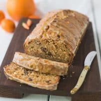 Carrot ginger spiced bread on a board with a knife and slices