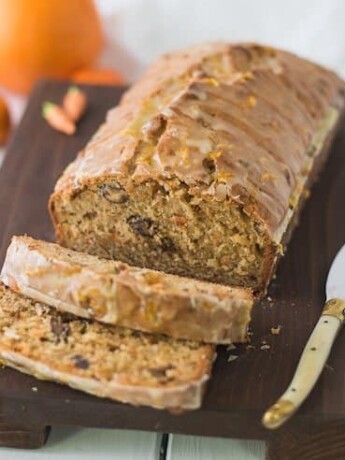 Carrot ginger spiced bread on a board with a knife and slices