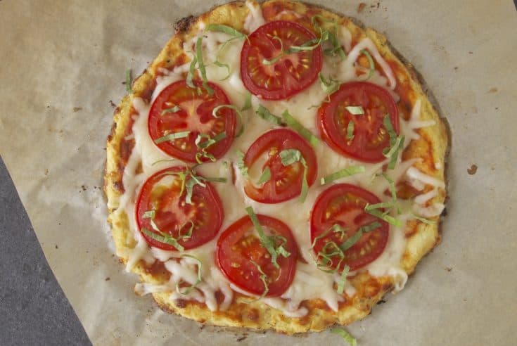 Cauliflower crust tomato basil pizza viewed from overhead