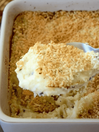 A casserole of mashed potatoes right out of the oven with a browned breadcrumb topping