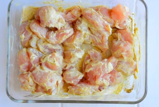 Chicken breast pieces marinating in spices and yogurt