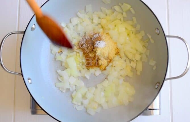 Cooking onions in a pan with spices
