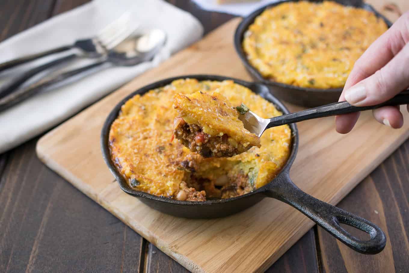 A closeup of a spoonful of chili and polenta