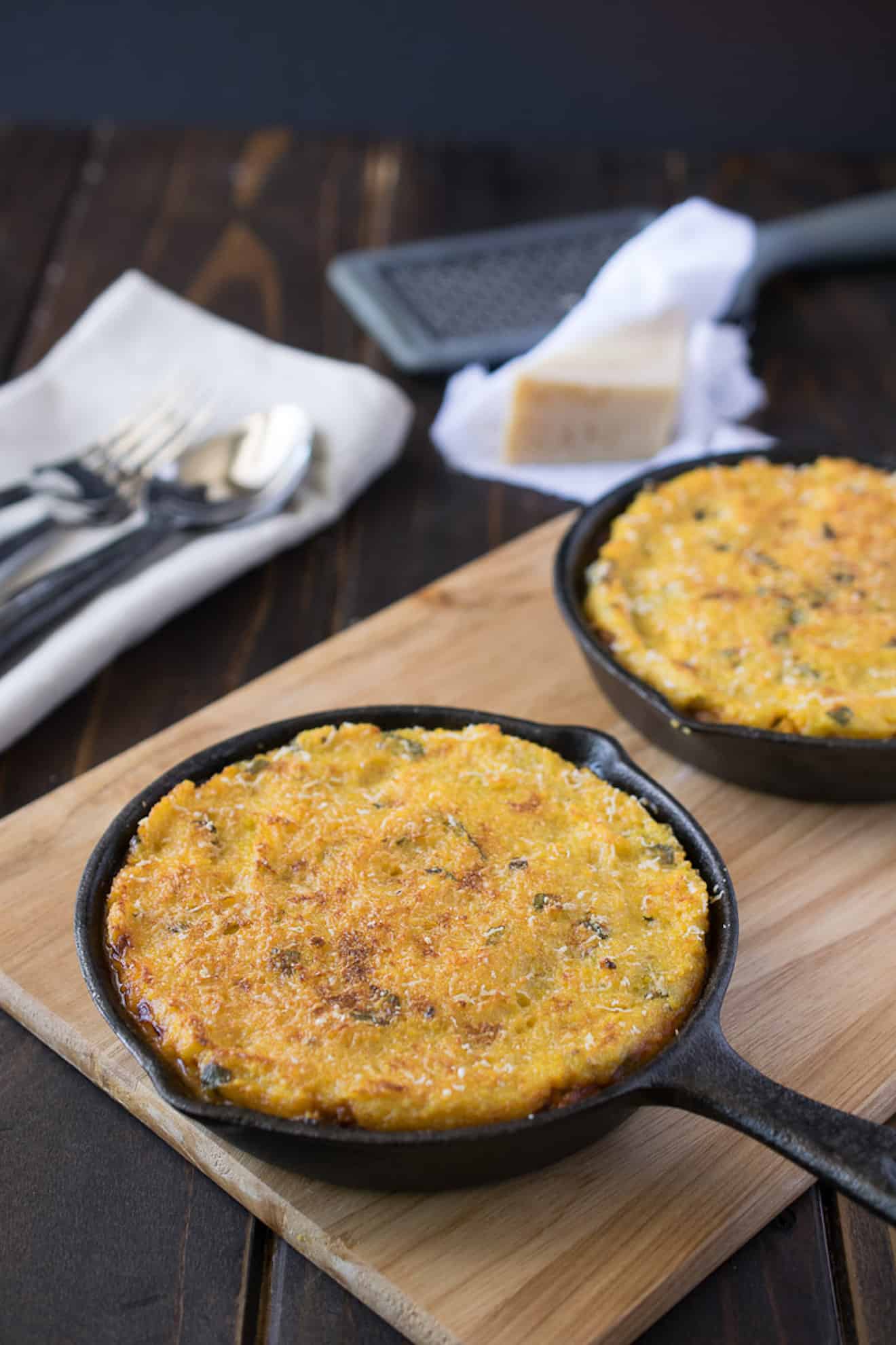 2 chili pies in cast iron skillets topped with polenta