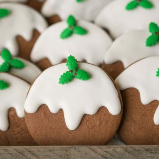 A closeup of the cookies showing the pretty fondant green holly and white frosting