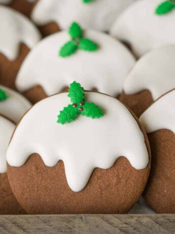 A closeup of the cookies showing the pretty fondant green holly and white frosting