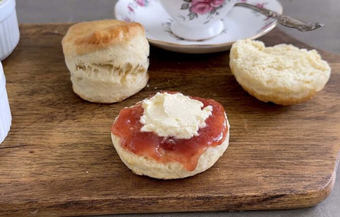 Fluffy homemade scones with strawberry jam and butter on wooden serving board, traditional breakfast bakery, soft baked pastries, fresh baked scones recipe, bakery dessert, culinary ginger image.