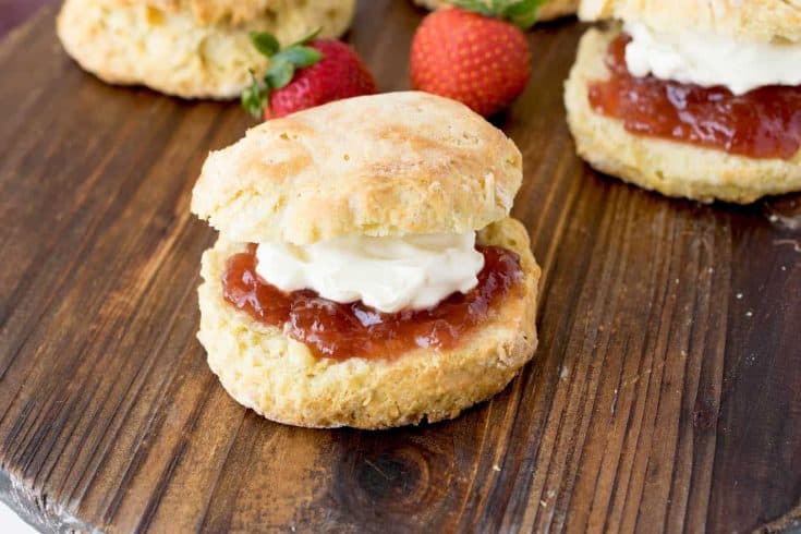 A Classic British Scone topped with strawberry jam and clotted cream