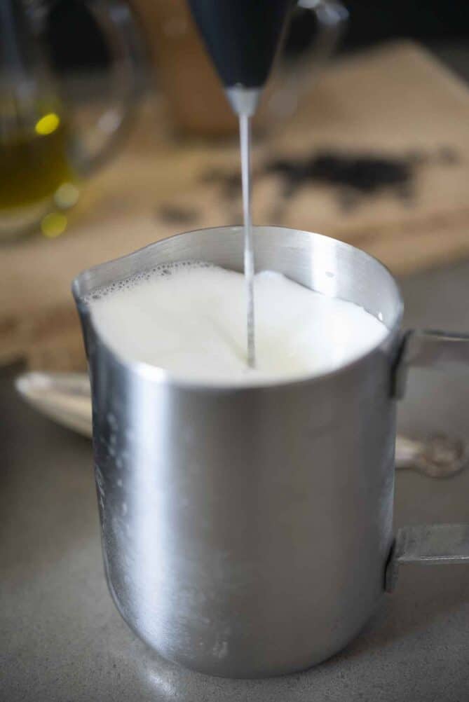 Frothing milk in a silver jug