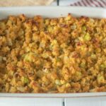 A rectangle baking dish with cornbread stuffing