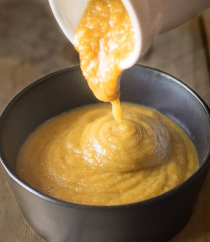 Pouring butternut squash puree into a bowl