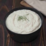 Creamy smooth fennel and leek puree in a black bowl
