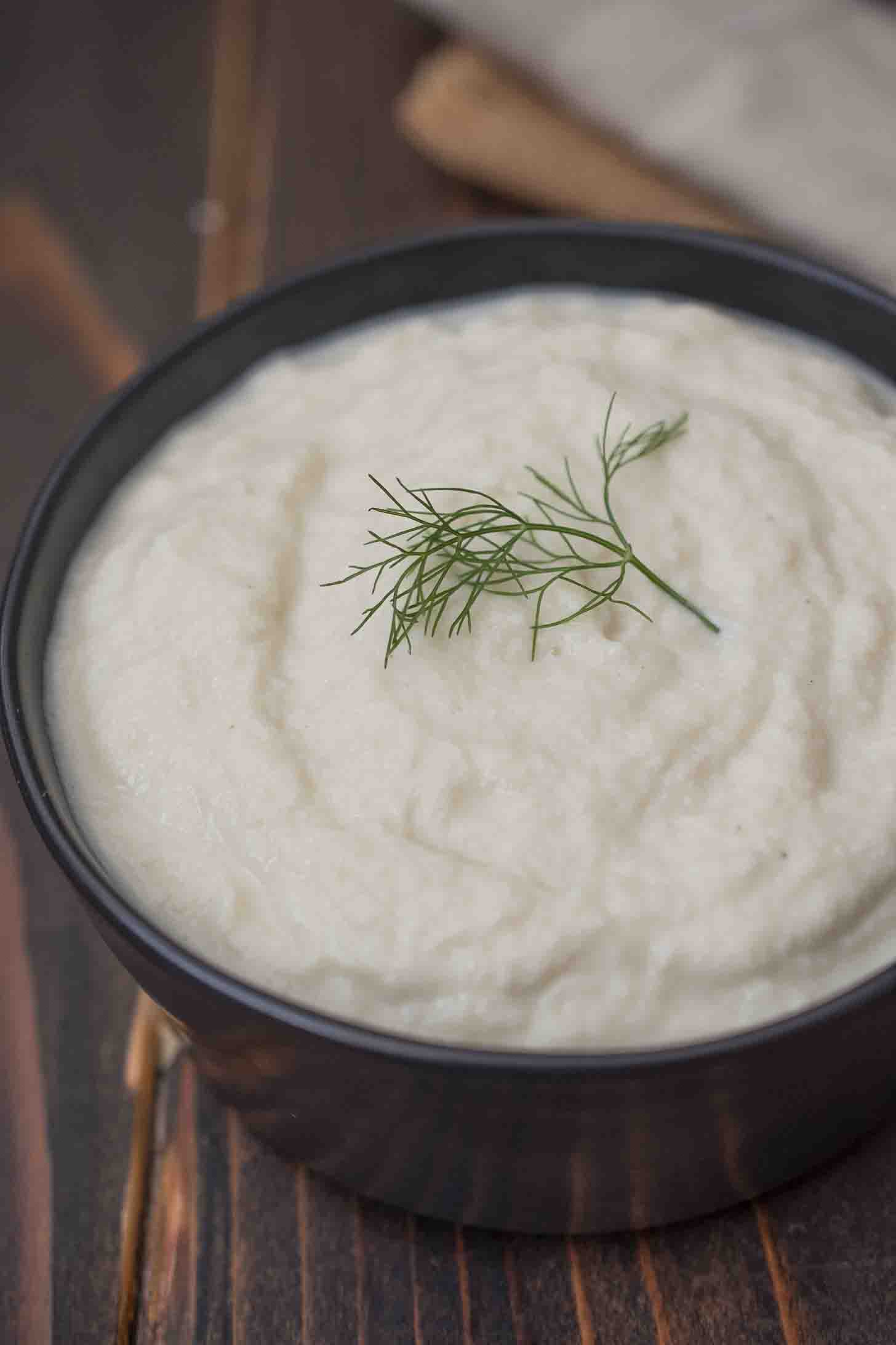 A closeup of blended fennel and leek garnished with a green leaf