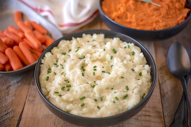 A black bowl filled with Creamy Microwave Mashed Potatoes