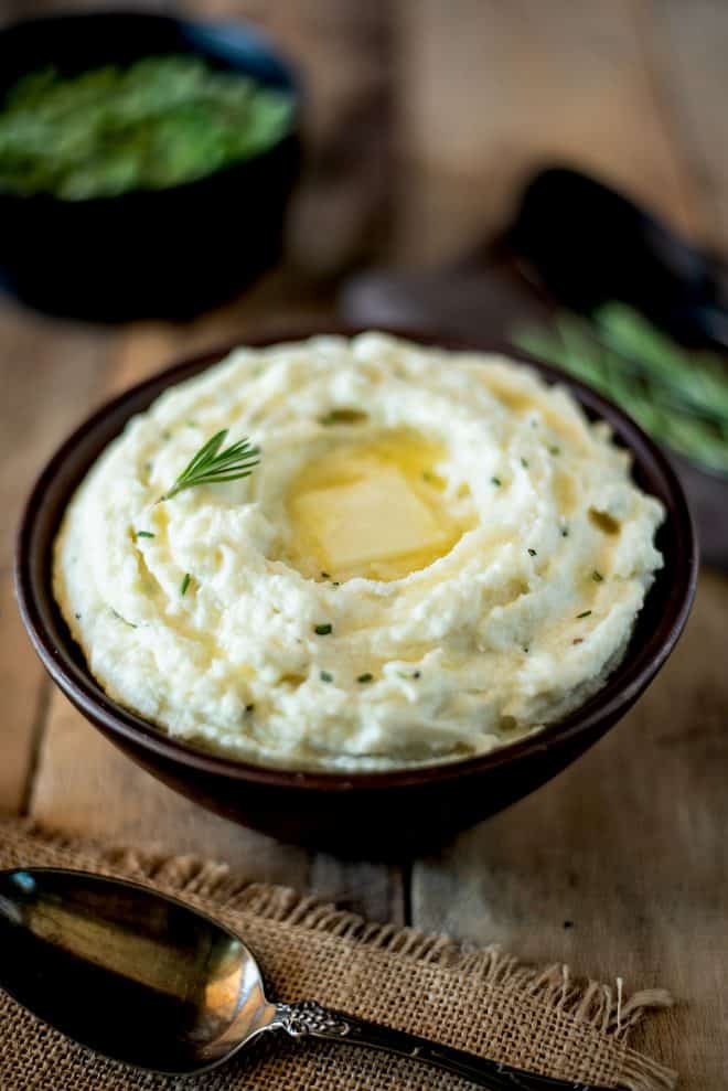 Creamy cauliflower mash made in the microwave topped with rosemary and melting butter