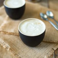 This creamy almond coconut cashew coffee will be your new chilly morning wake-me-up drink that is dairy free. Healthy almond milk is blended and thickened with coconut oil, cashews and a little honey for a creamy coffee creamer. This is Bulletproof coffee meets healthy latte.
