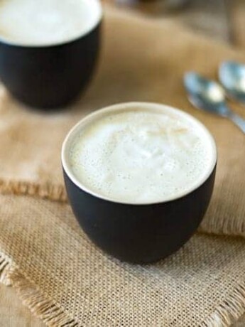 This creamy almond coconut cashew coffee will be your new chilly morning wake-me-up drink that is dairy free. Healthy almond milk is blended and thickened with coconut oil, cashews and a little honey for a creamy coffee creamer. This is Bulletproof coffee meets healthy latte.