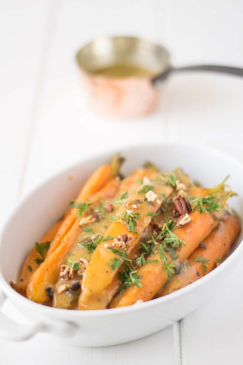 Crockpot orange, honey and herb glazed carrots are a stunning side dish that will be a stunning addition to your holiday or Sunday dinner table.