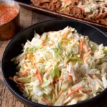 Colorful coleslaw in a black bowl