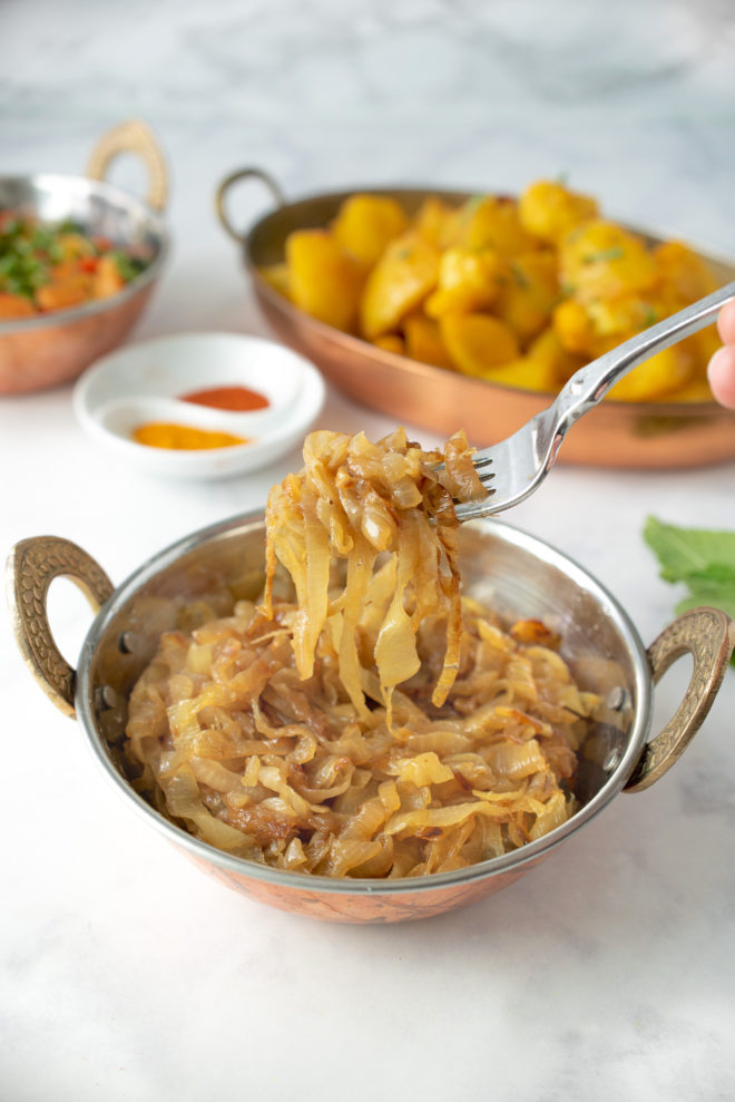 A fork full of curry caramelized onions