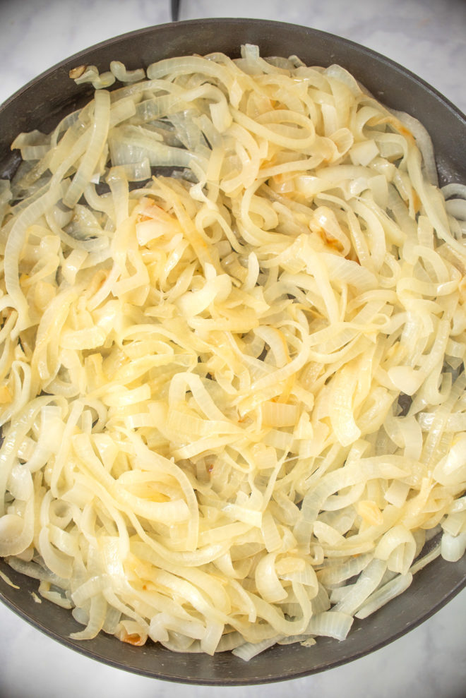A large pan full of sliced onions