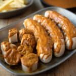 3 whole sausages and 1 cut into slices covered with currywurst sauce