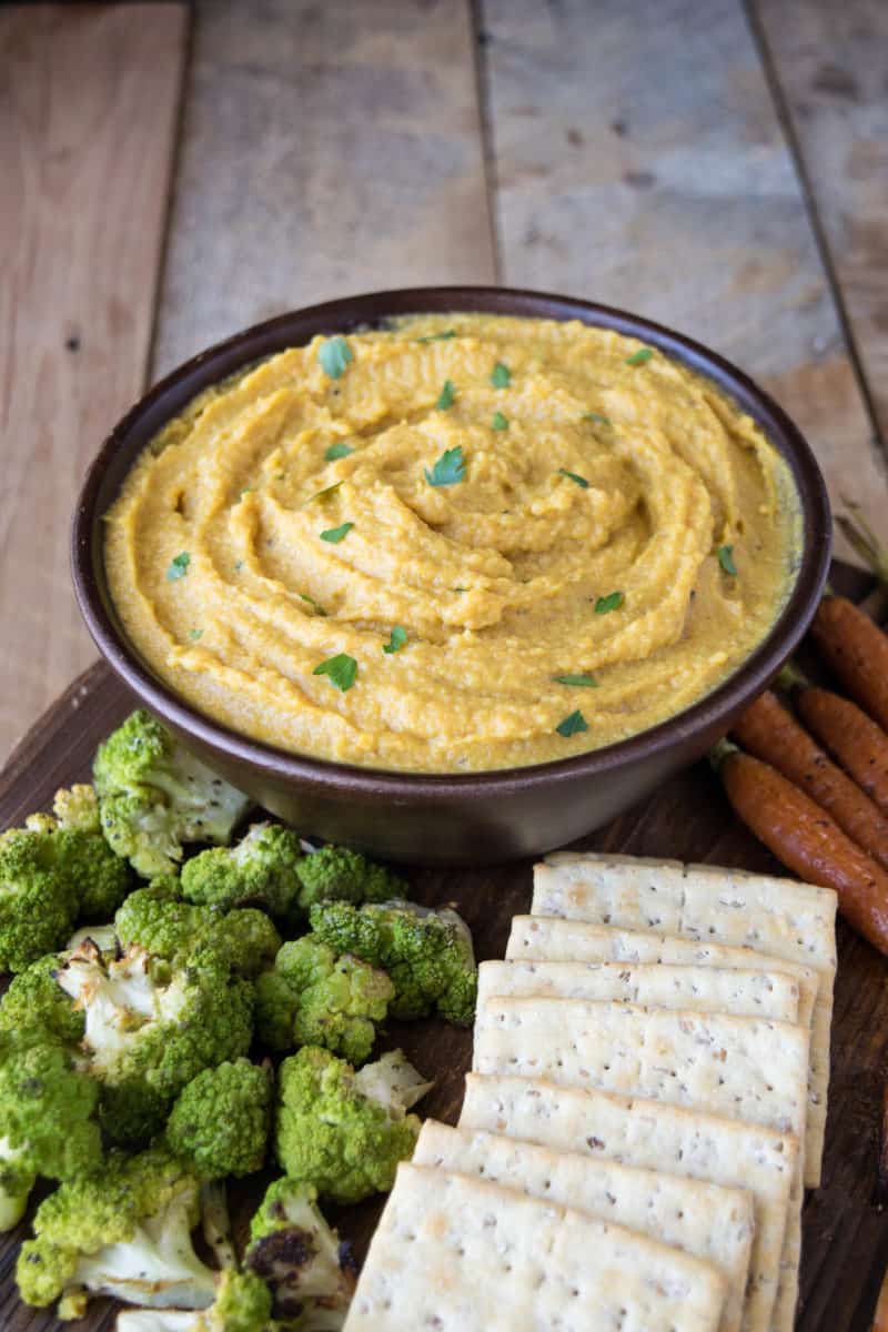 Curry roasted butternut squash and apple dip is a delicious coming together of two seasonal fruits and vegetables. Perfect for fall entertaining and served at room temperature with baked pita chips, roasted veggies or crackers.