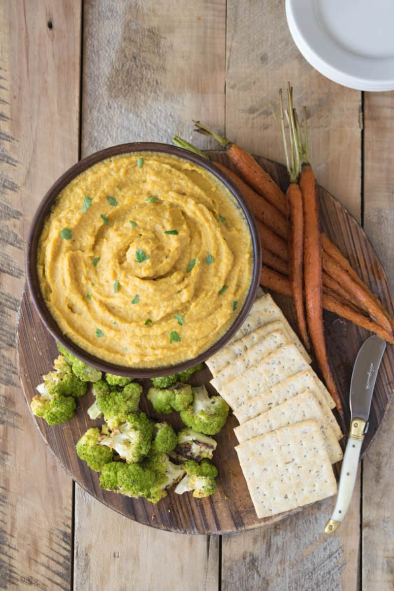 Curry roasted butternut squash and apple dip is a delicious coming together of two seasonal fruits and vegetables. Perfect for fall entertaining and served at room temperature with baked pita chips, roasted veggies or crackers.
