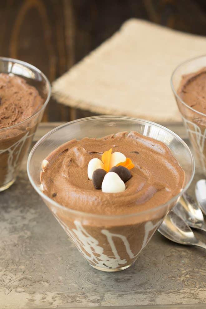 Dark chocolate espresso mousse in a glass bowl topped with white and dark chocolate