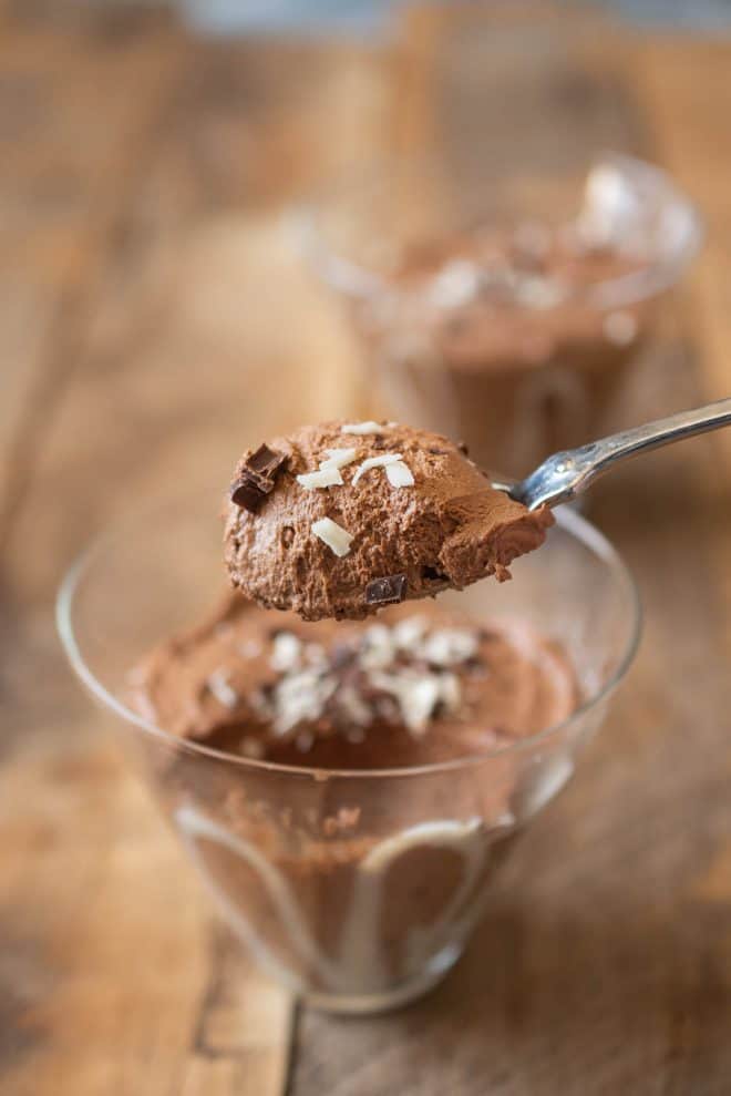 A spoonful of dark chocolate espresso mousse topped with grated chocolate