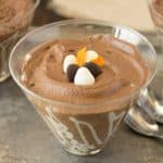 A closeup of a bowl of dark chocolate espresso mousse with 3 spoons