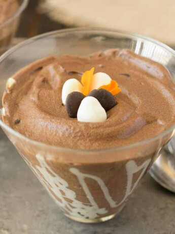 A closeup of a bowl of dark chocolate espresso mousse with 3 spoons