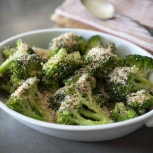 Cooked broccoli in a white oval dish
