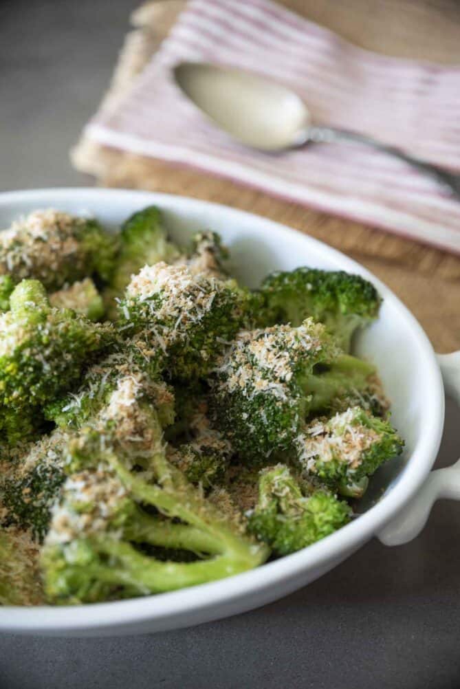 Bright green broccoli crowns in a serving dish