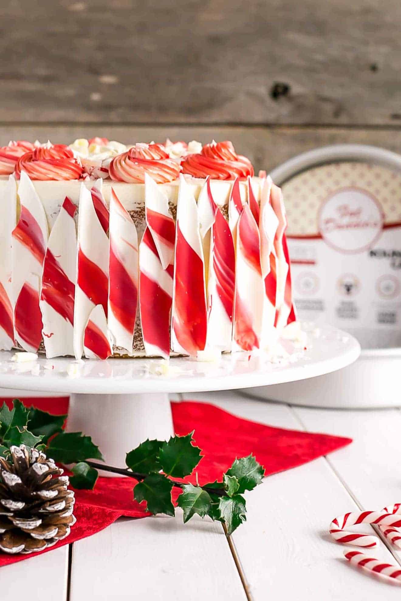 Red and white chocolate decorate the sides of a cake