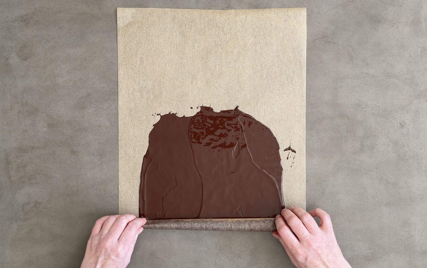Rolling melted chocolate inside parchment paper