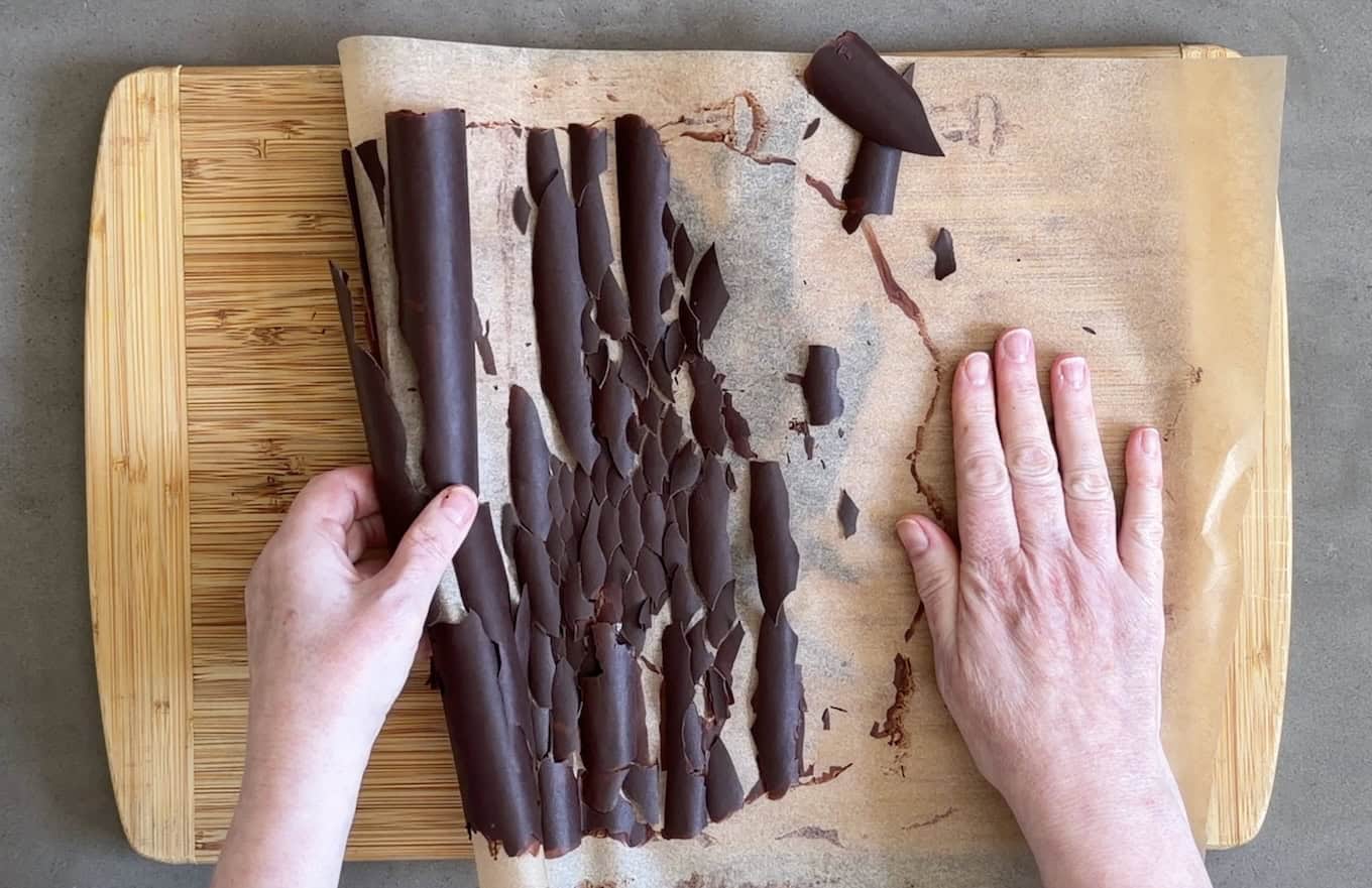 Unrolling parchment paper to create chocolate shards