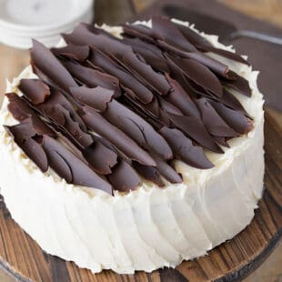 Jagged shards of chocolate on top of a white cake