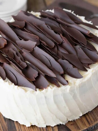 Jagged shards of chocolate on top of a white cake